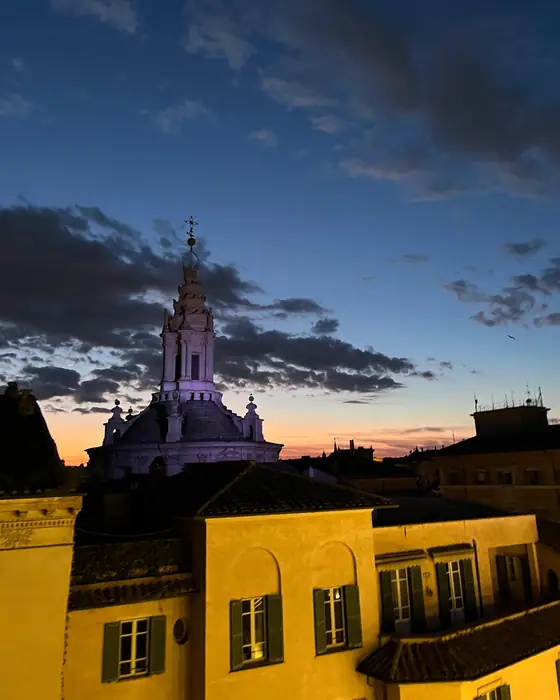 The lantern of Sant'Ivo alla Sapienza over the rooftops of Rome at dusk